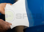 protective peelable paint being peeled from a painted metal surface