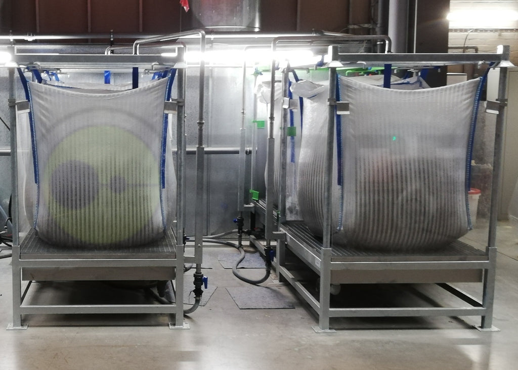 photo showing 4 Bigfloc units being used to filter paint solids from water within a furniture manufacturing facility