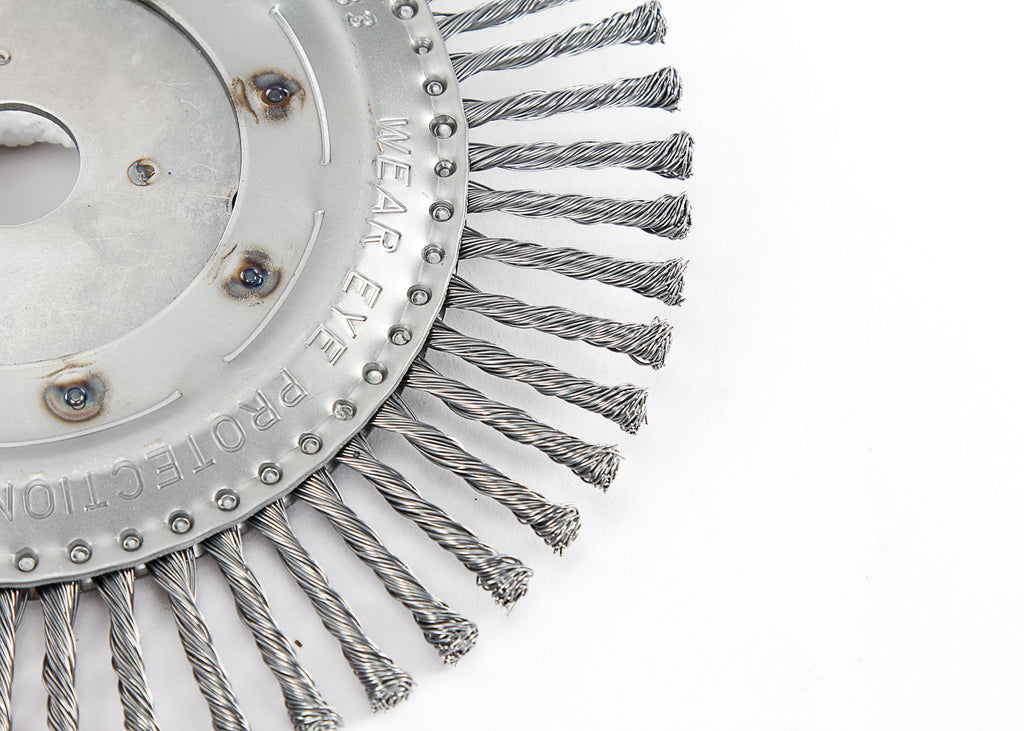 A close-up of a steel bevel brush with twisted bristles and a central shaft. Robust and durable cleaning tool designed for heavy-duty applications.