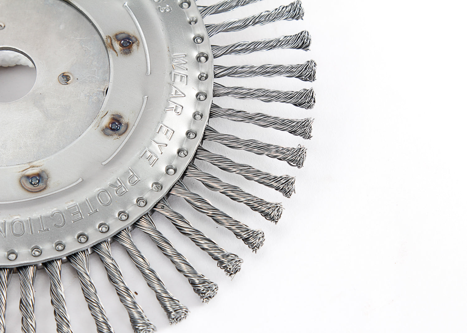 A close-up of a steel bevel brush with twisted bristles and a central shaft. Robust and durable cleaning tool designed for heavy-duty applications.