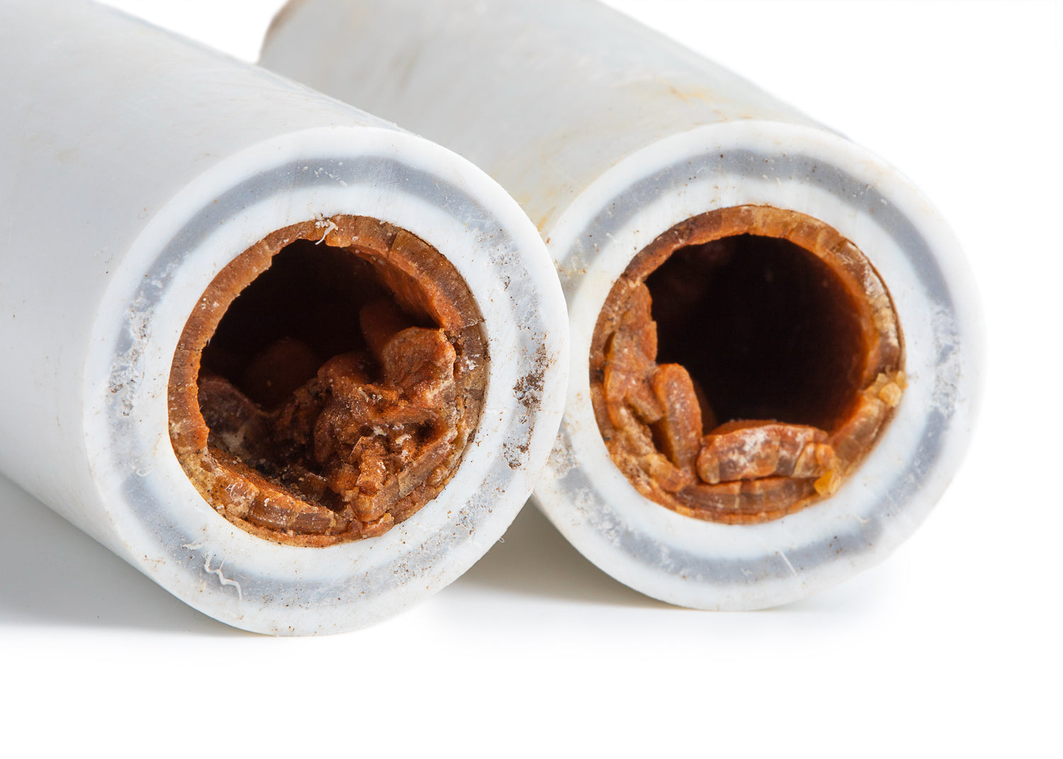 photo showing how a pipe can block with the build up of scale and sludge.  Detartrol will soften and remove this leading to improved flow and functionality.
