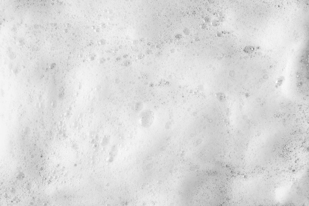 photo of thick foam and bubbles on surface of water in industrial booth