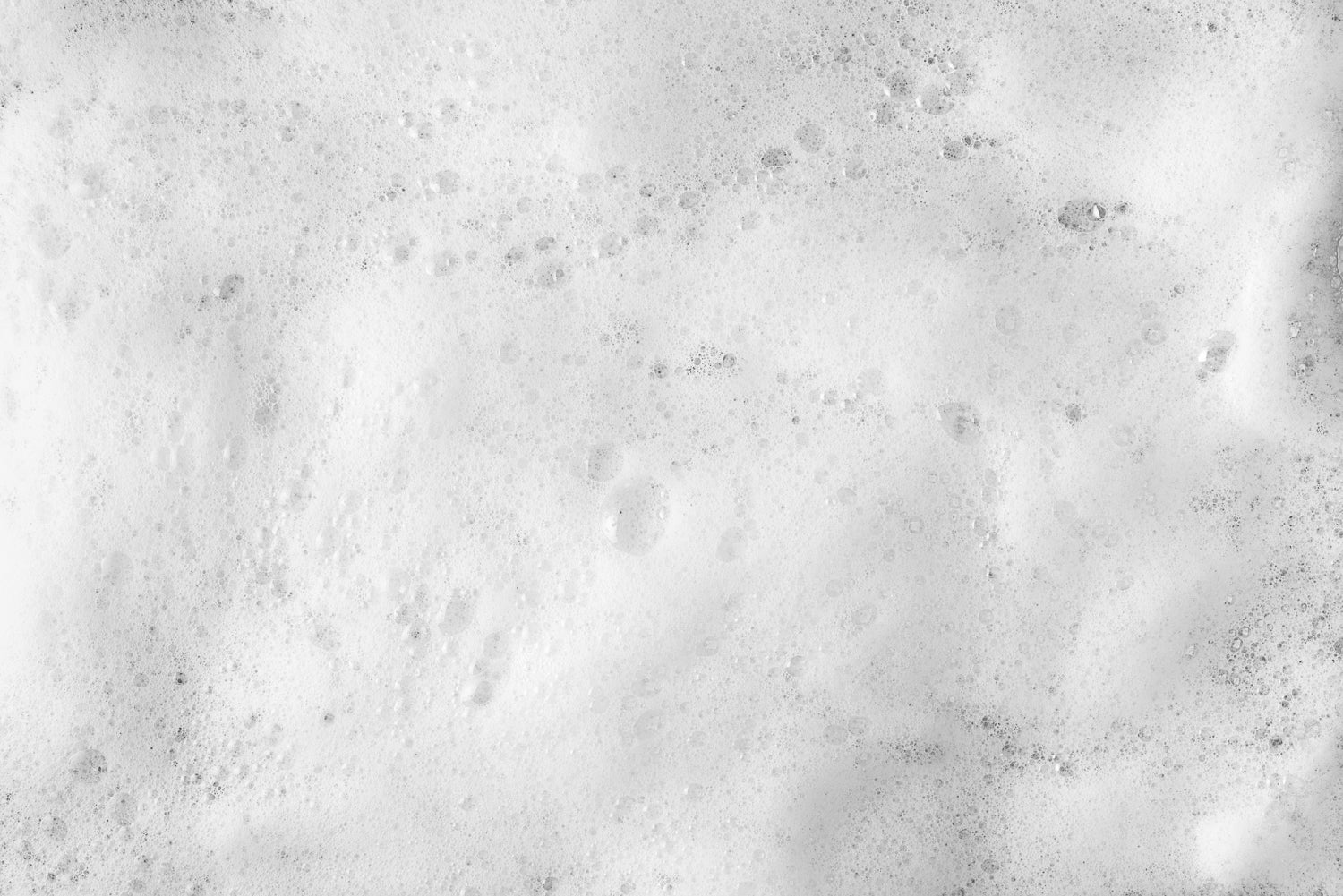 photo of thick foam and bubbles on surface of water in industrial booth