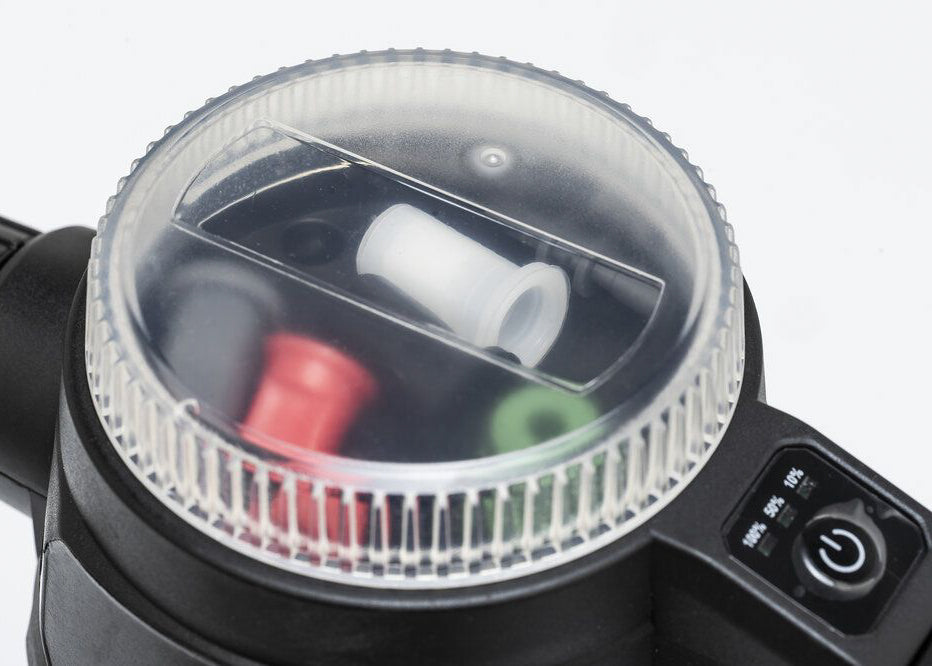 close up of the locking lid of our foaming electric sprayer showing replacement nozzles, battery level indicator, and on off switch