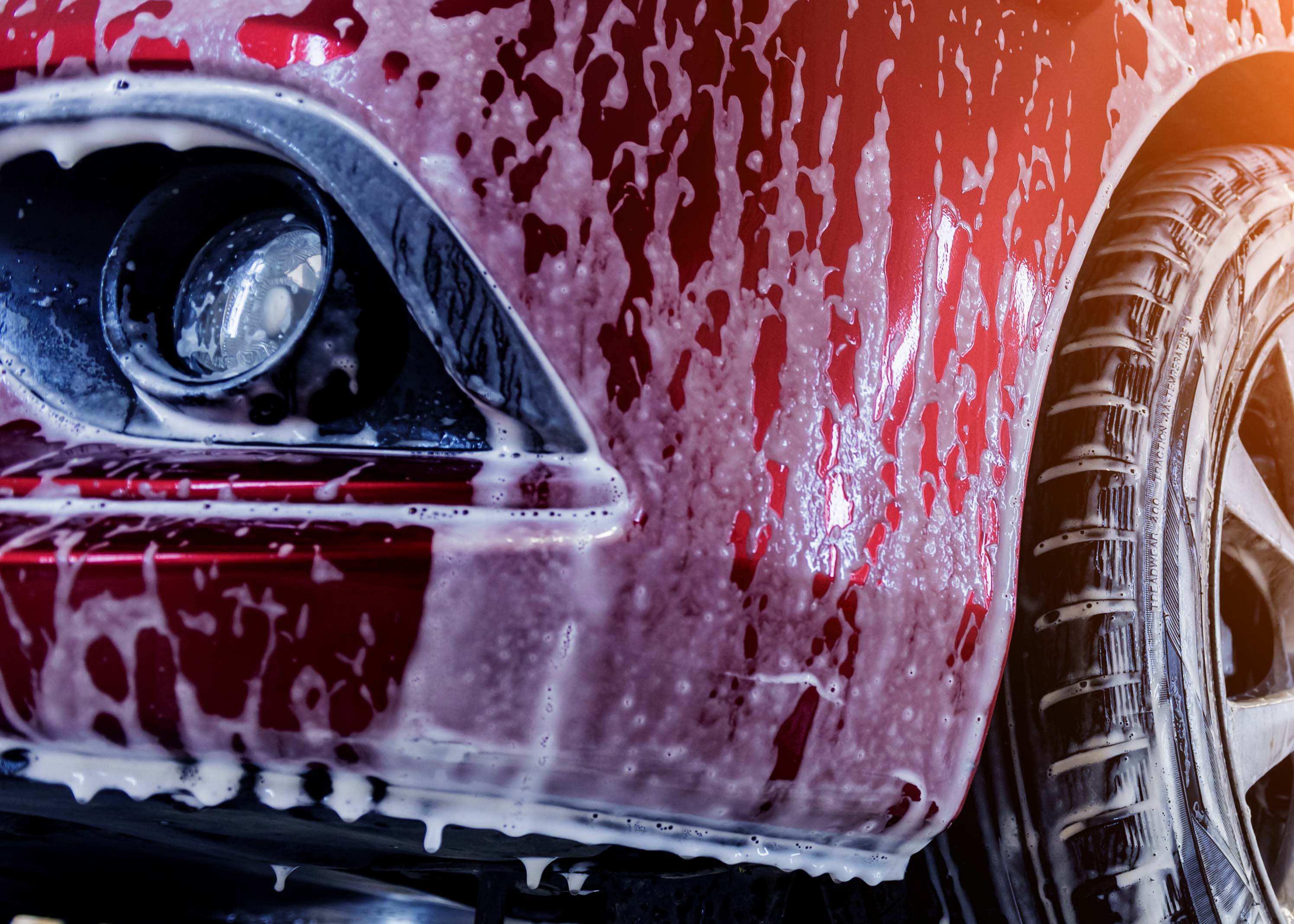 close up of a car being cleaned with high concentrate foaming detergent