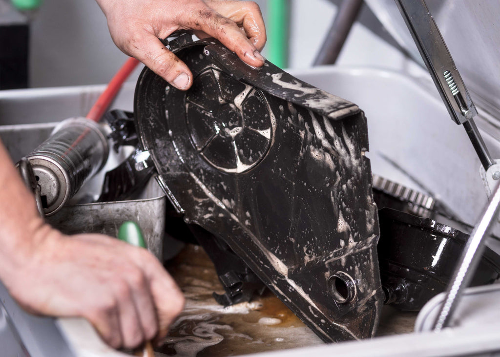removing oil and grease from an automotive part
