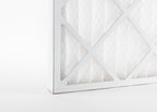 close up photo showing a pleated spray booth dust filter and its cardboard frame