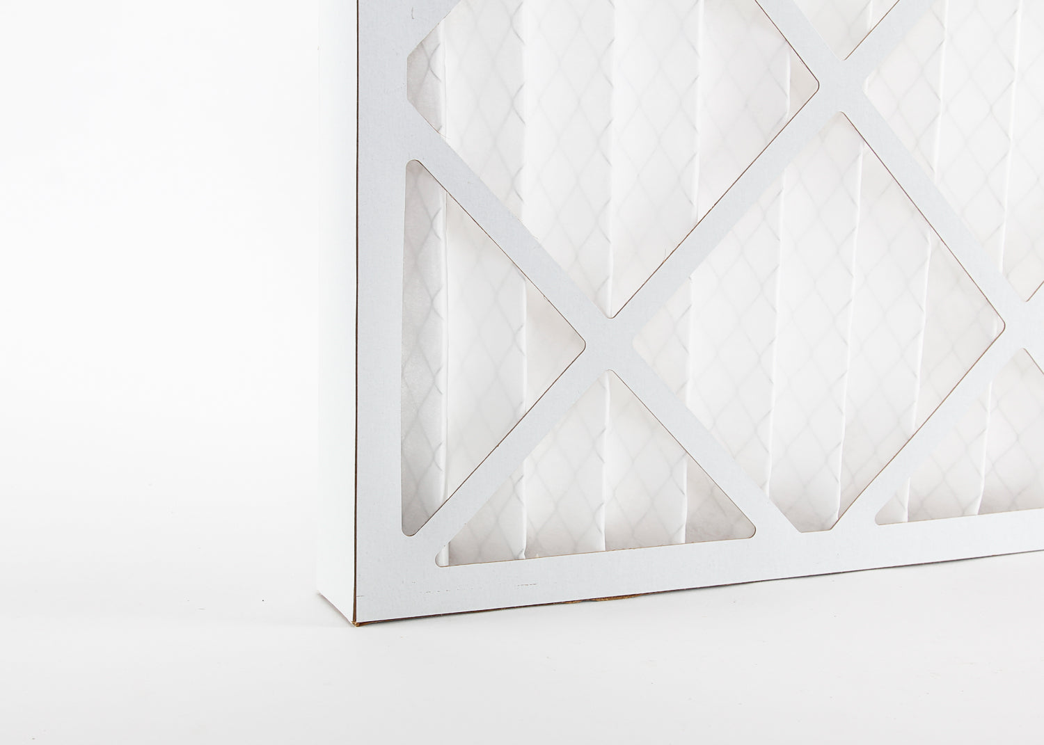 close up photo showing a pleated spray booth dust filter and its cardboard frame