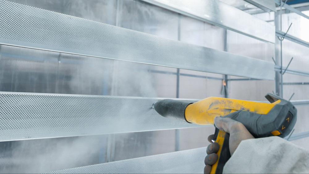 spraying powder paint within a wet spray booth