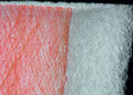 Close-up of our red and white paint stop spray booth filter designed for trapping dust and particles in industrial settings.
