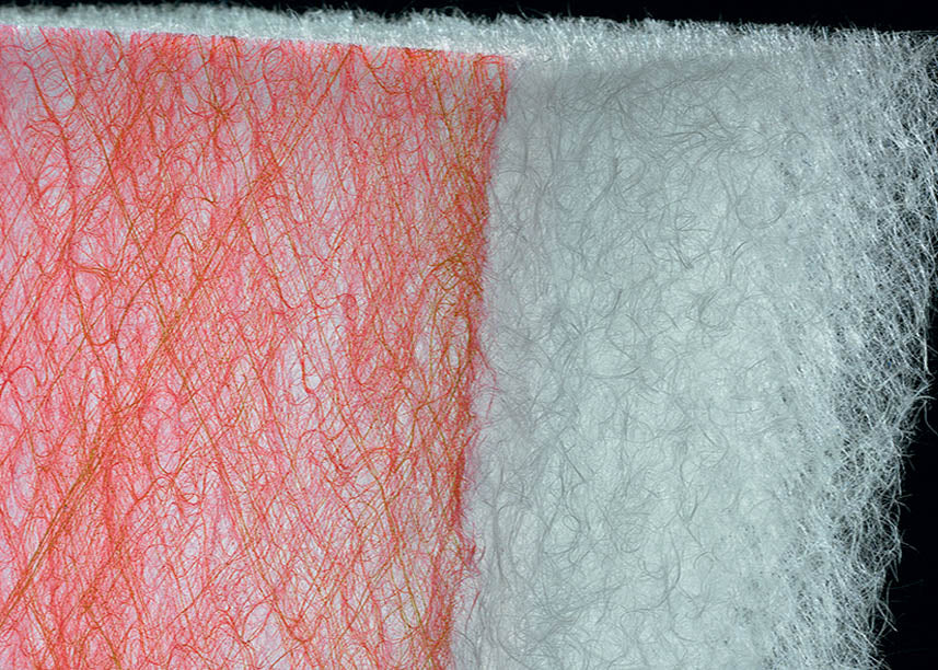 Close-up of our red and white paint stop spray booth filter designed for trapping dust and particles in industrial settings.