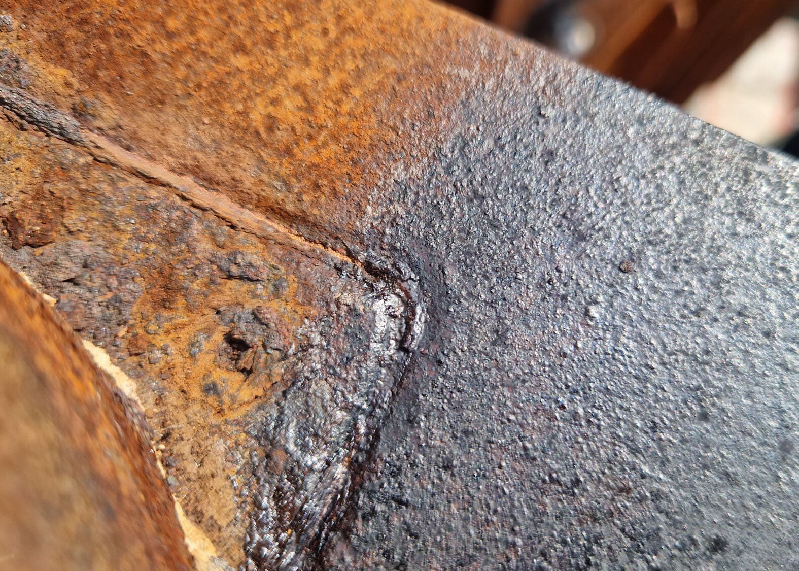 photo of a treated rusty surface showing the treated and untreated surface